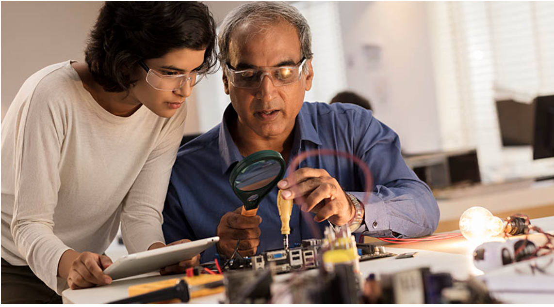 Engineers inspecting an electronic circuit board