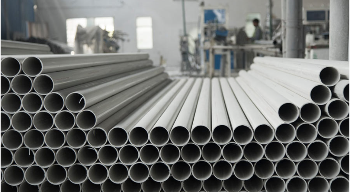 Stacked PVC pipes in a manufacturing facility
